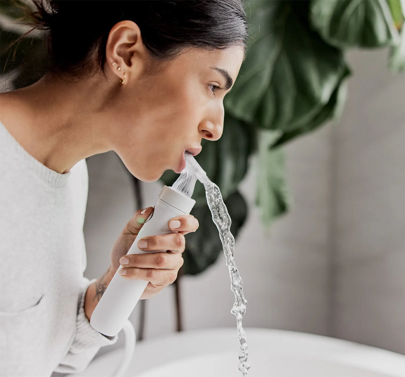 Woman using the custom jet oral health system