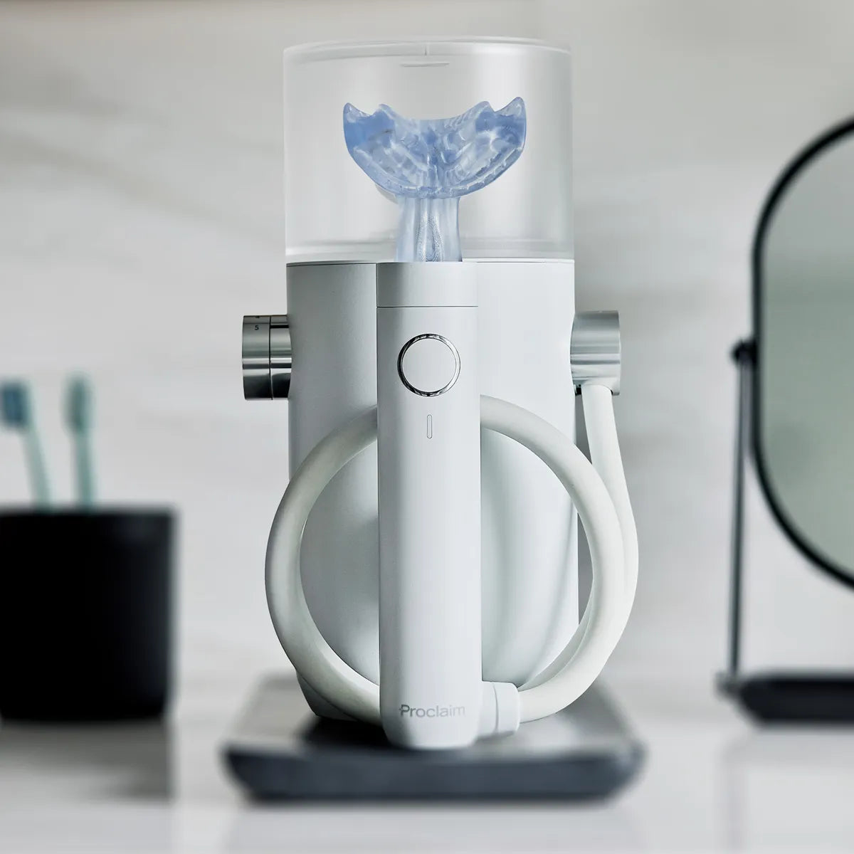 Proclaim Custom-Jet Oral Health System headon in a white marble bathroom
