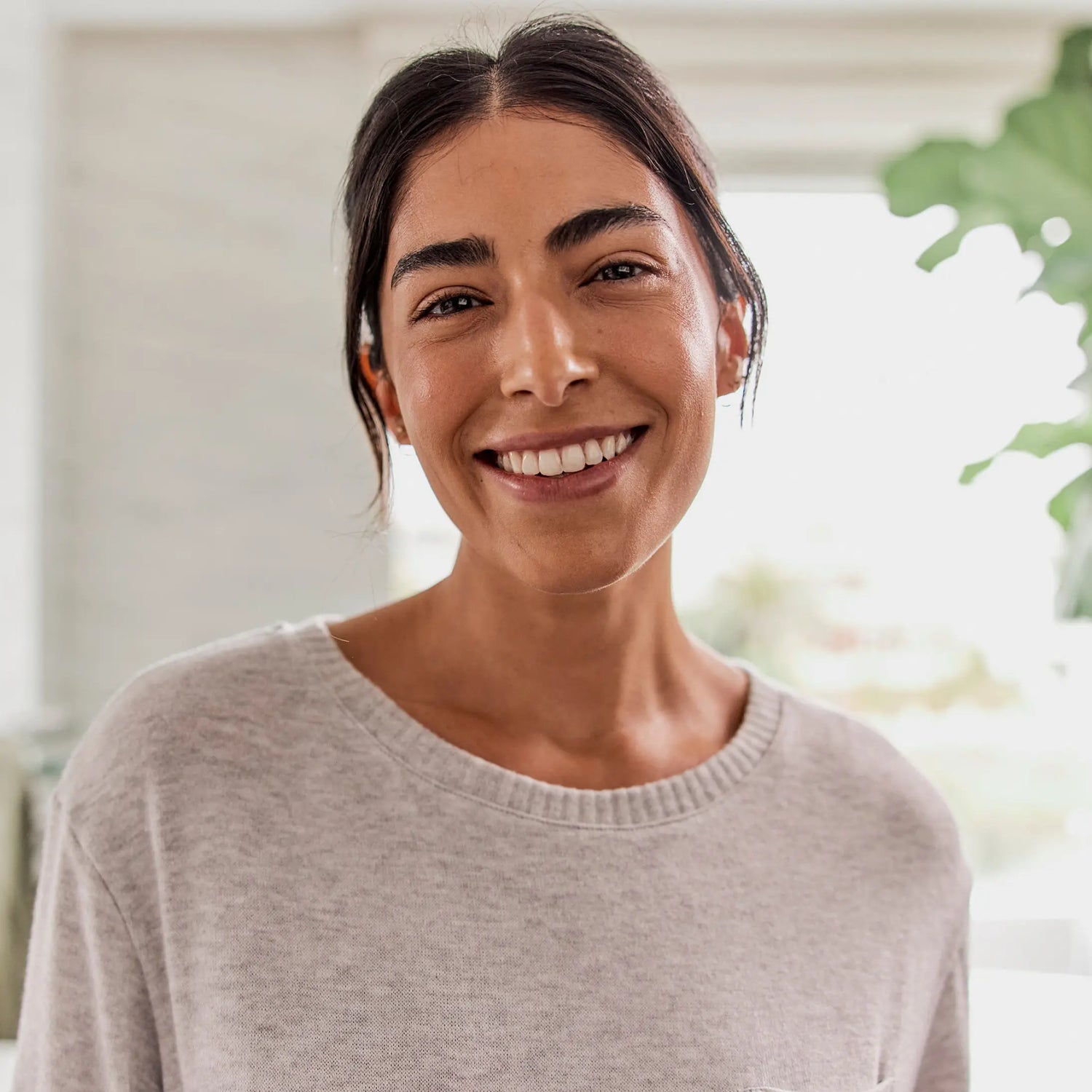Woman smiling after using her proclaim oral health system